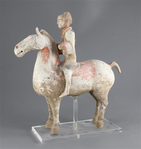 A Chinese pottery group of a horse and rider, Han dynasty, height 35cm, length 33.5cm